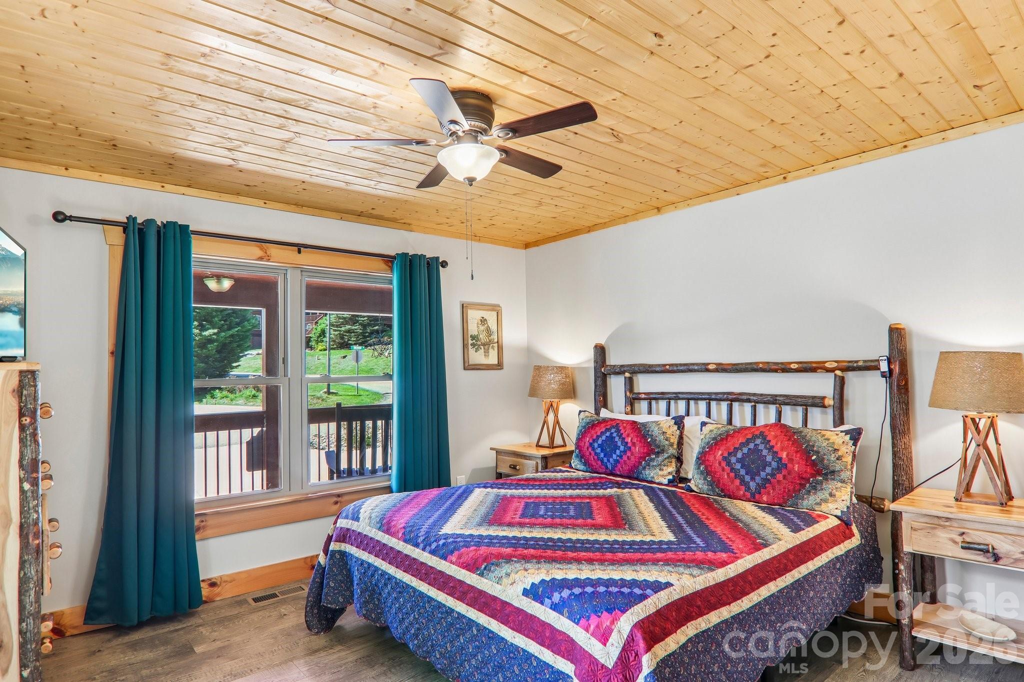 589 Panoramic Loop Maggie Valley, NC 28751 - Photo 22 of 47 a bedroom with a bed and wooden floor