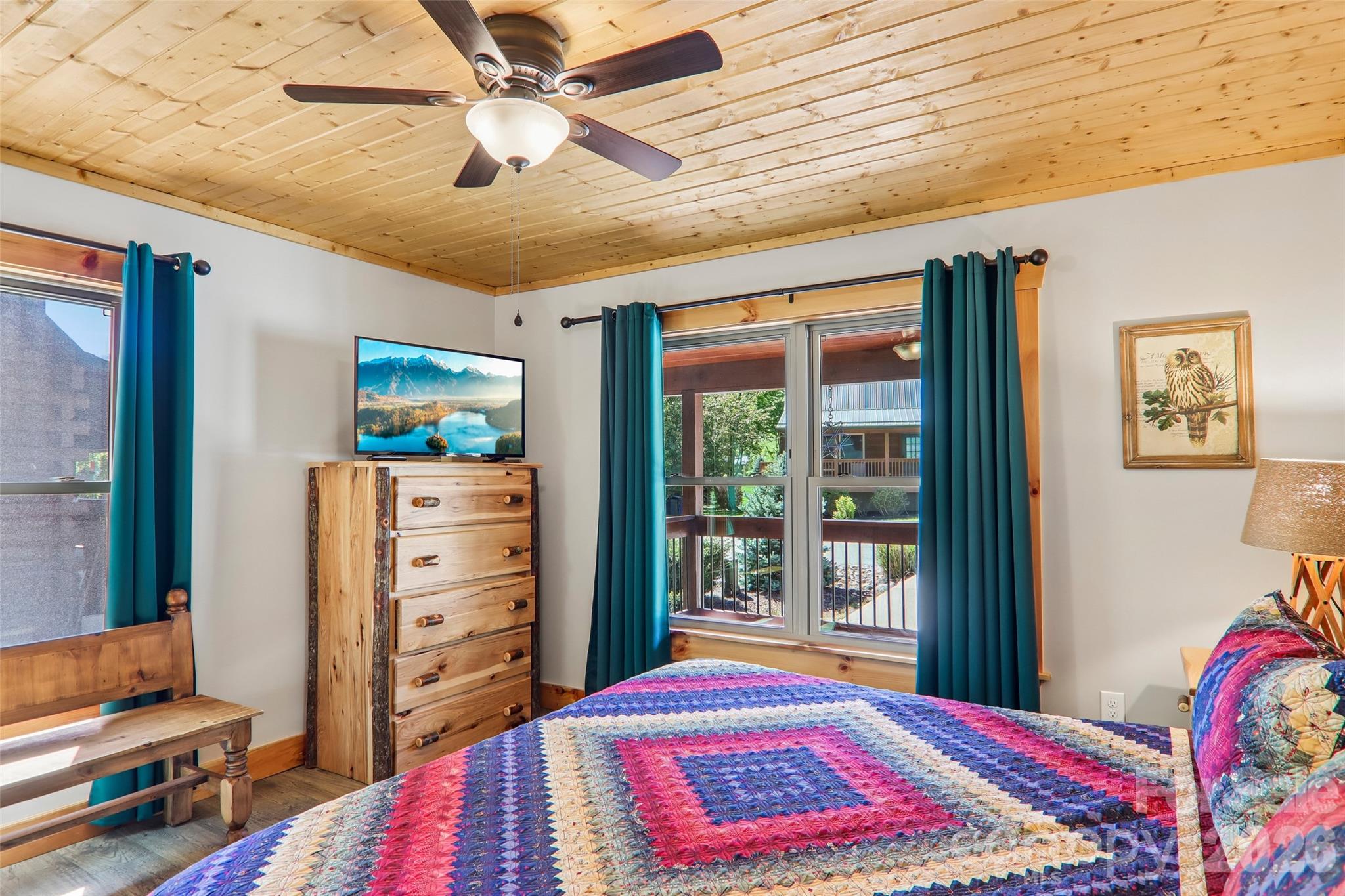 589 Panoramic Loop Maggie Valley, NC 28751 - Photo 23 of 47 a bedroom with a bed and a chandelier