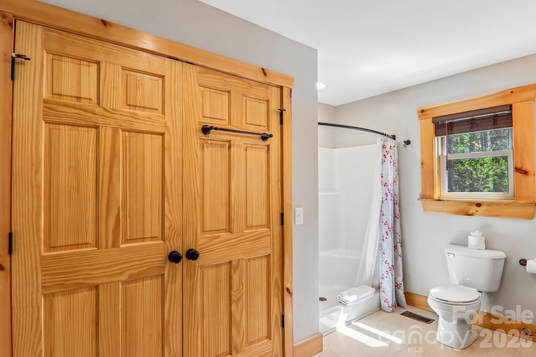 589 Panoramic Loop Maggie Valley, NC 28751 - Photo 27 of 47 a bathroom with a granite countertop sink a toilet and shower