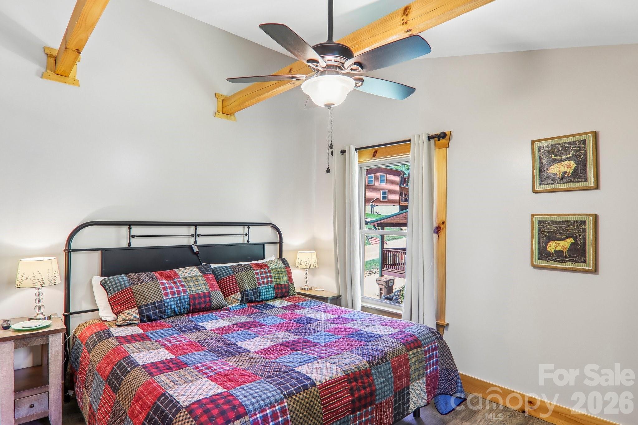 589 Panoramic Loop Maggie Valley, NC 28751 - Photo 30 of 47 a bedroom with a bed and a chandelier