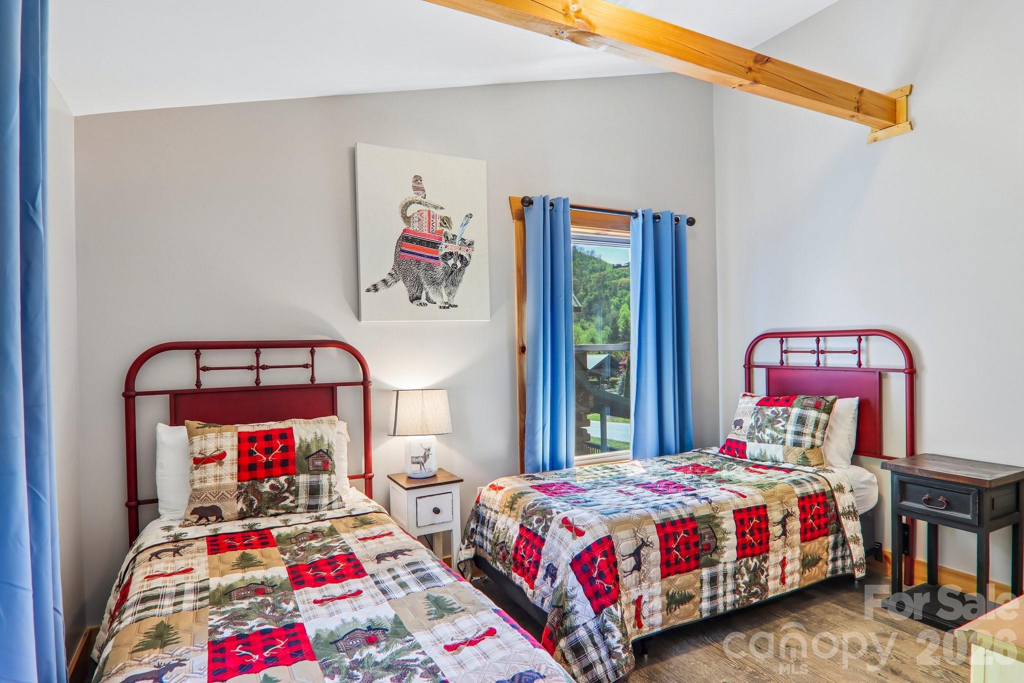 589 Panoramic Loop Maggie Valley, NC 28751 - Photo 34 of 47 a bedroom with a bed and a painting on the wall