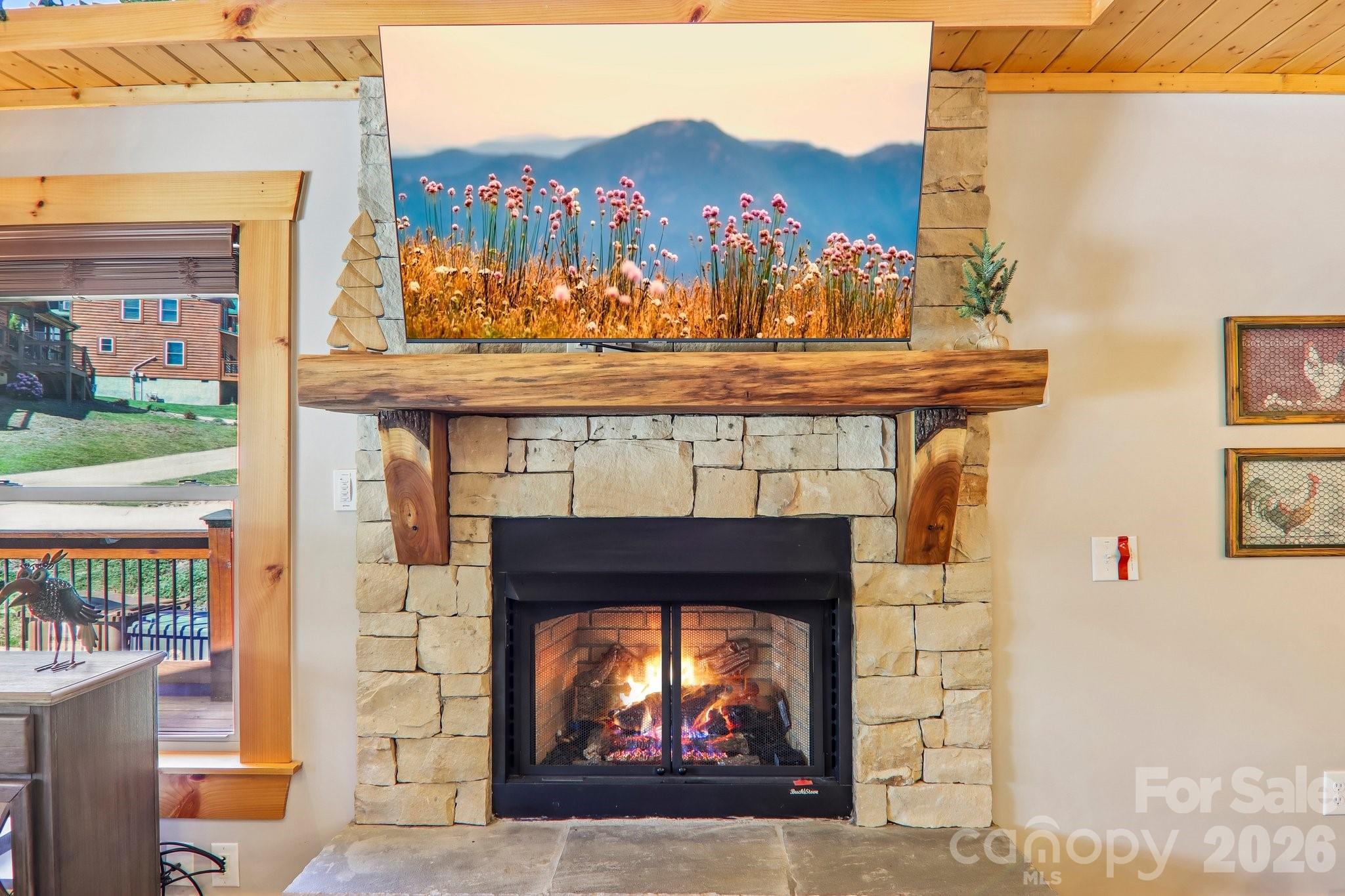 589 Panoramic Loop Maggie Valley, NC 28751 - Photo 4 of 47 a fireplace with a clock on top of it
