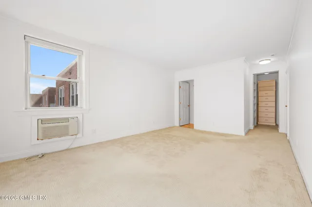 a living room with a large window and a potted plant