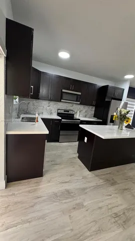 a kitchen with a sink and a stove top oven