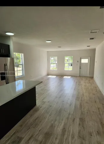 a view of wooden floor and windows in a room