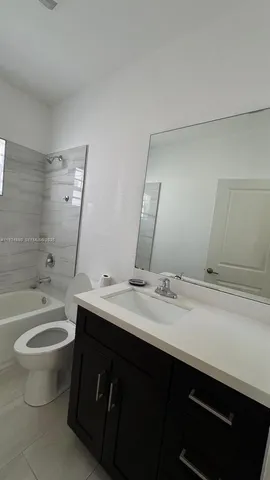 a bathroom with a double vanity sink and a bathtub