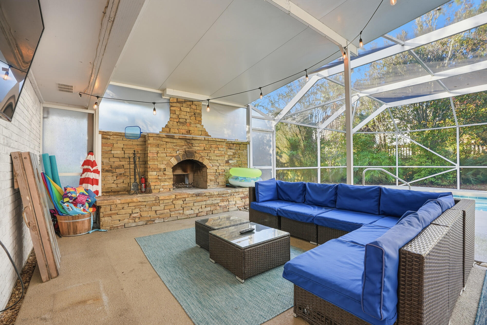18 Initial Lane Santa Rosa Beach, FL 32459 - Photo 42 of 60 a living room with furniture a fireplace and a floor to ceiling window