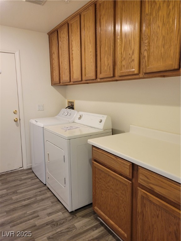 1112 Nevada Blaze Avenue North Las Vegas, NV 89081 - Photo 19 of 22 Laundry area featuring cabinet space, dark wood-type flooring, and independent washer and dryer