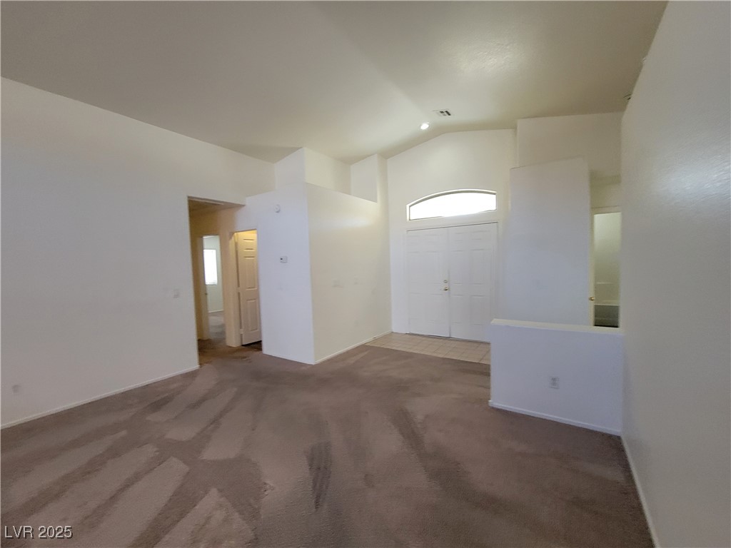 1112 Nevada Blaze Avenue North Las Vegas, NV 89081 - Photo 5 of 22 Carpeted entrance foyer featuring high vaulted ceiling and plenty of natural light