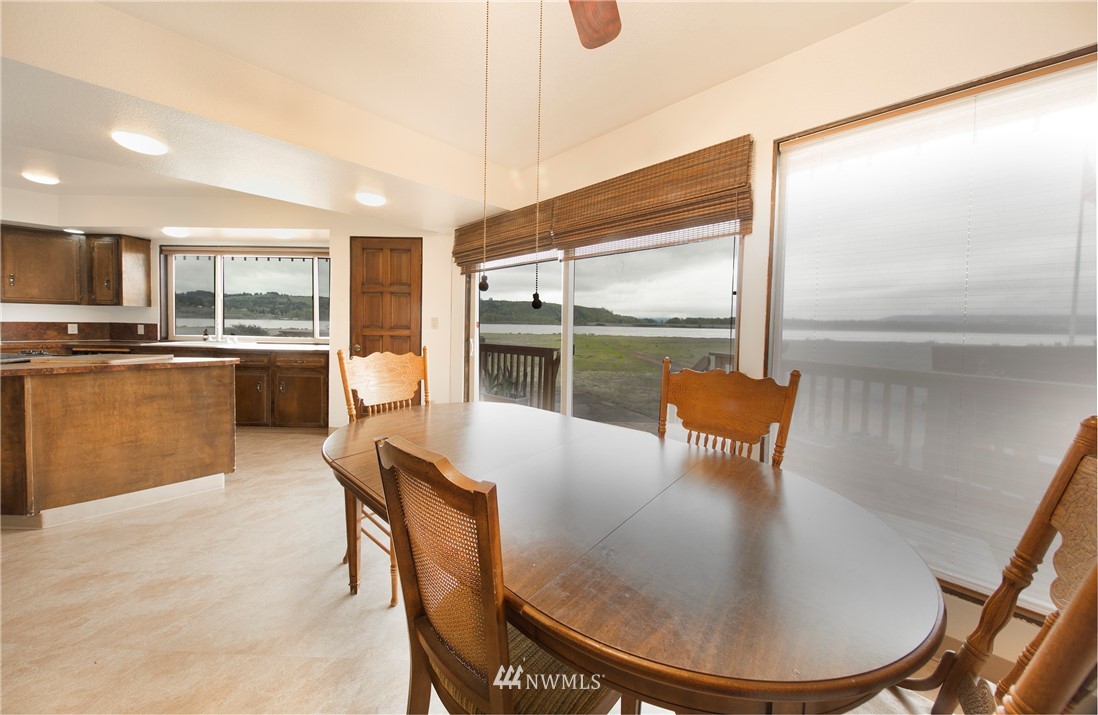 7461 Willow Grove Road Longview, WA 98632 - Photo 15 of 31 a dining room with furniture a window and kitchen view