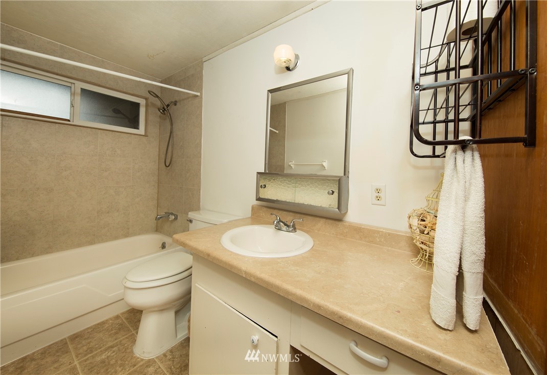 7461 Willow Grove Road Longview, WA 98632 - Photo 30 of 31 a bathroom with a granite countertop sink and a mirror