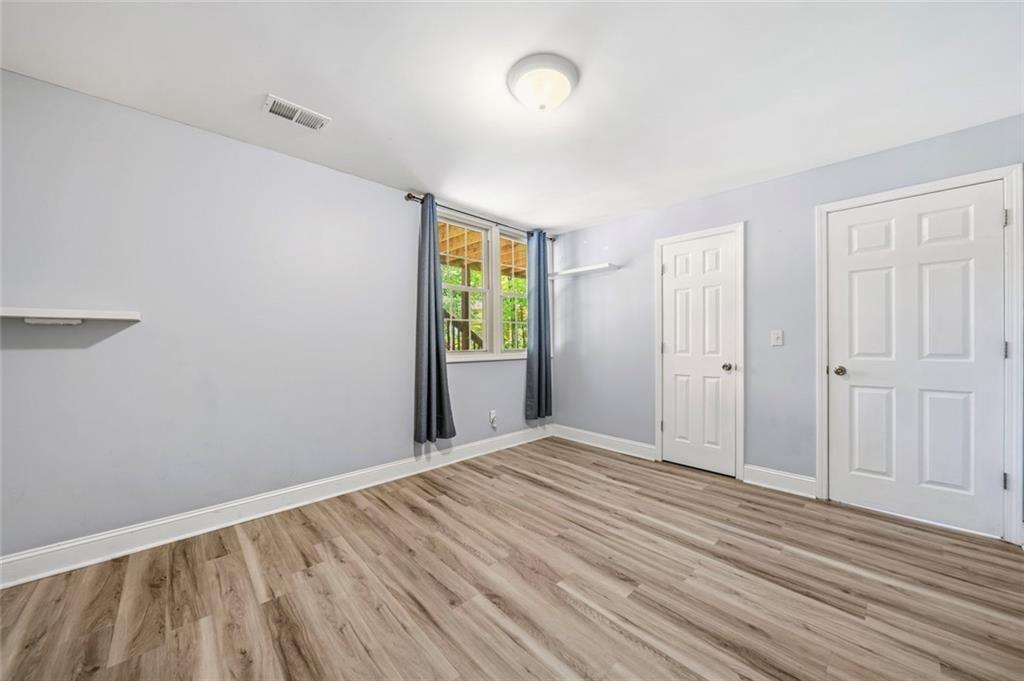 2702 Davenport Road Northwest Duluth, GA 30096 - Photo 27 of 48 a view of an empty room with wooden floor and a window