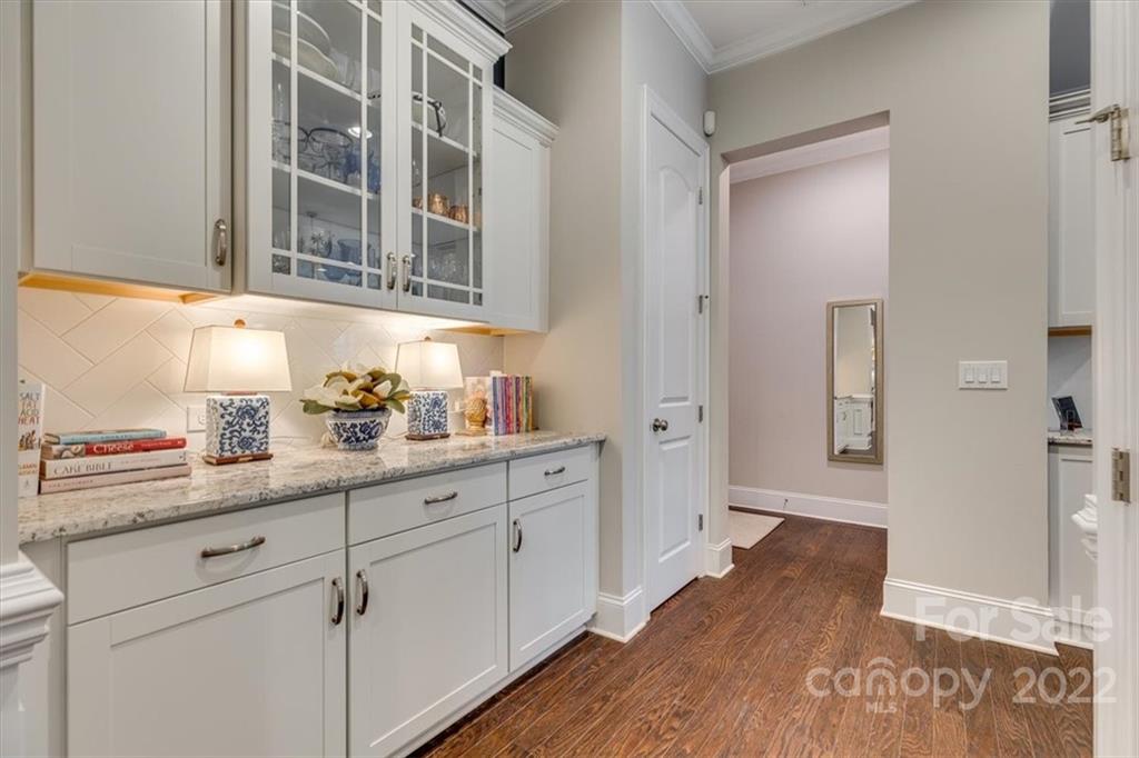 1489 Afton Way Fort Mill, SC 29708 - Photo 16 of 48 a hallway with cabinets and wooden floor