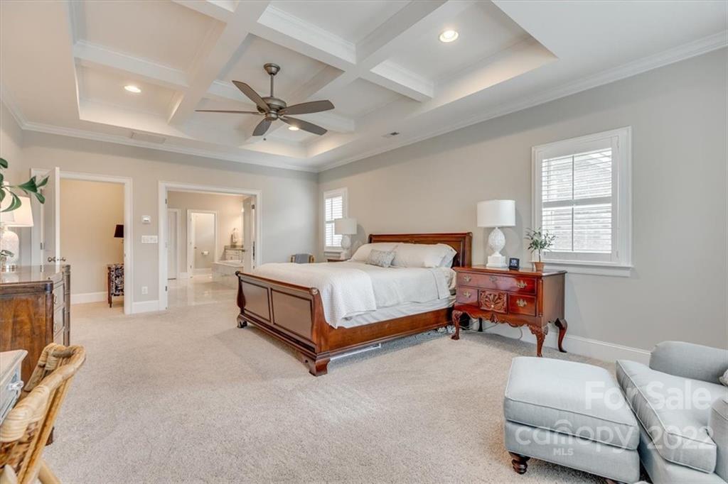 1489 Afton Way Fort Mill, SC 29708 - Photo 23 of 48 a bedroom with a bed and a chandelier