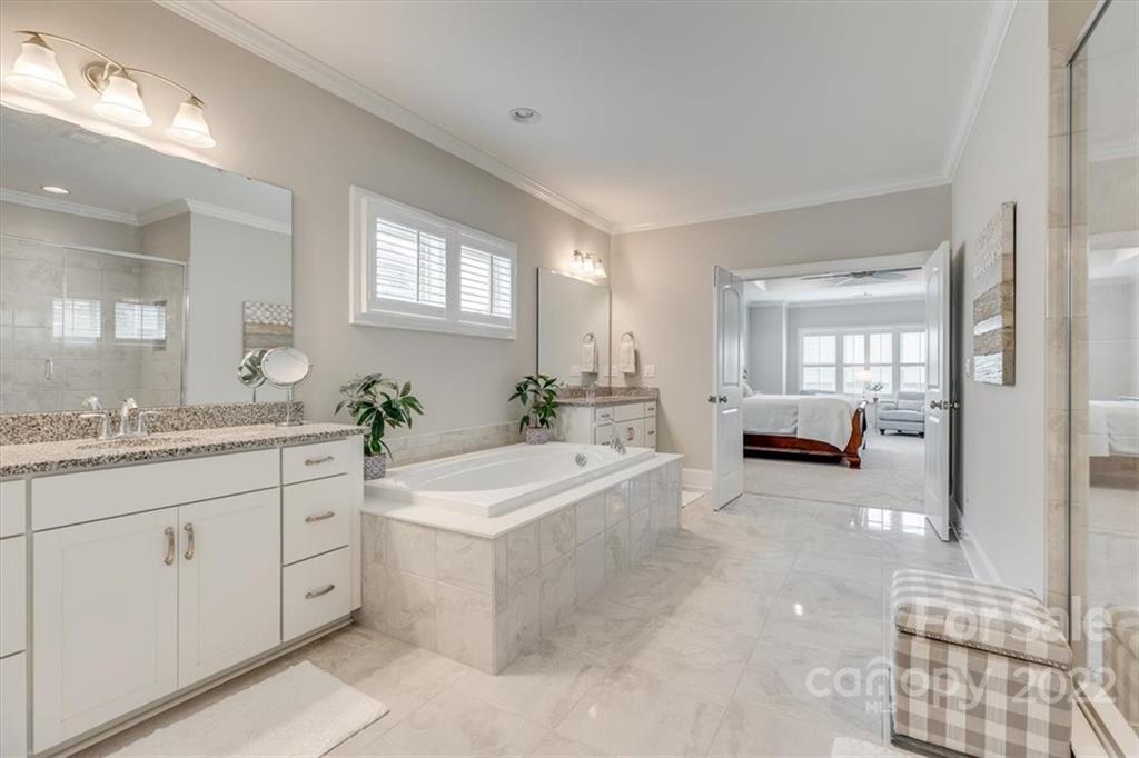1489 Afton Way Fort Mill, SC 29708 - Photo 26 of 48 a spacious bathroom with a sink mirror and a bath tub