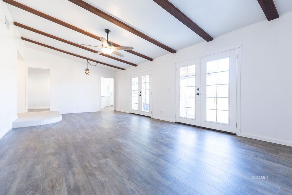 725 Randall Street Ridgecrest, CA 93555 - Photo 12 of 36 a view of an empty room with wooden floor and a window