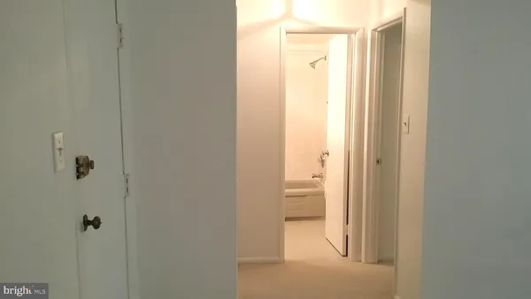 a white toilet sitting next to a bath tub