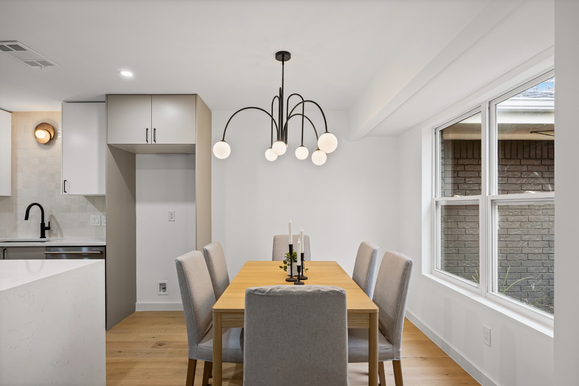 4609 Cliffstone Cove Austin, TX 78735 - Photo 13 of 33 Dining area featuring light wood-type flooring, a chandelier, and recessed lighting