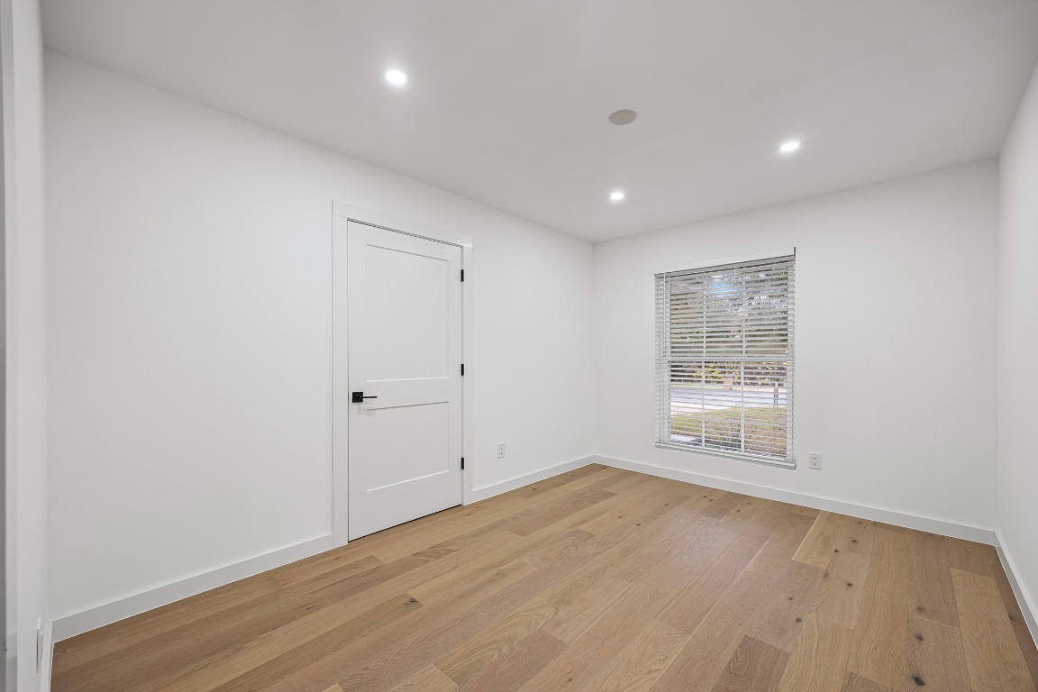 4609 Cliffstone Cove Austin, TX 78735 - Photo 15 of 33 Empty room featuring light wood-style floors and recessed lighting