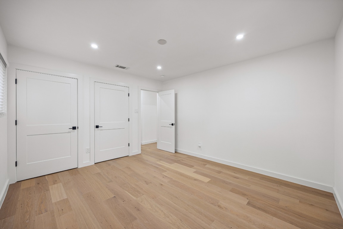 4609 Cliffstone Cove Austin, TX 78735 - Photo 18 of 33 Unfurnished bedroom with light wood-style flooring, recessed lighting, and a closet