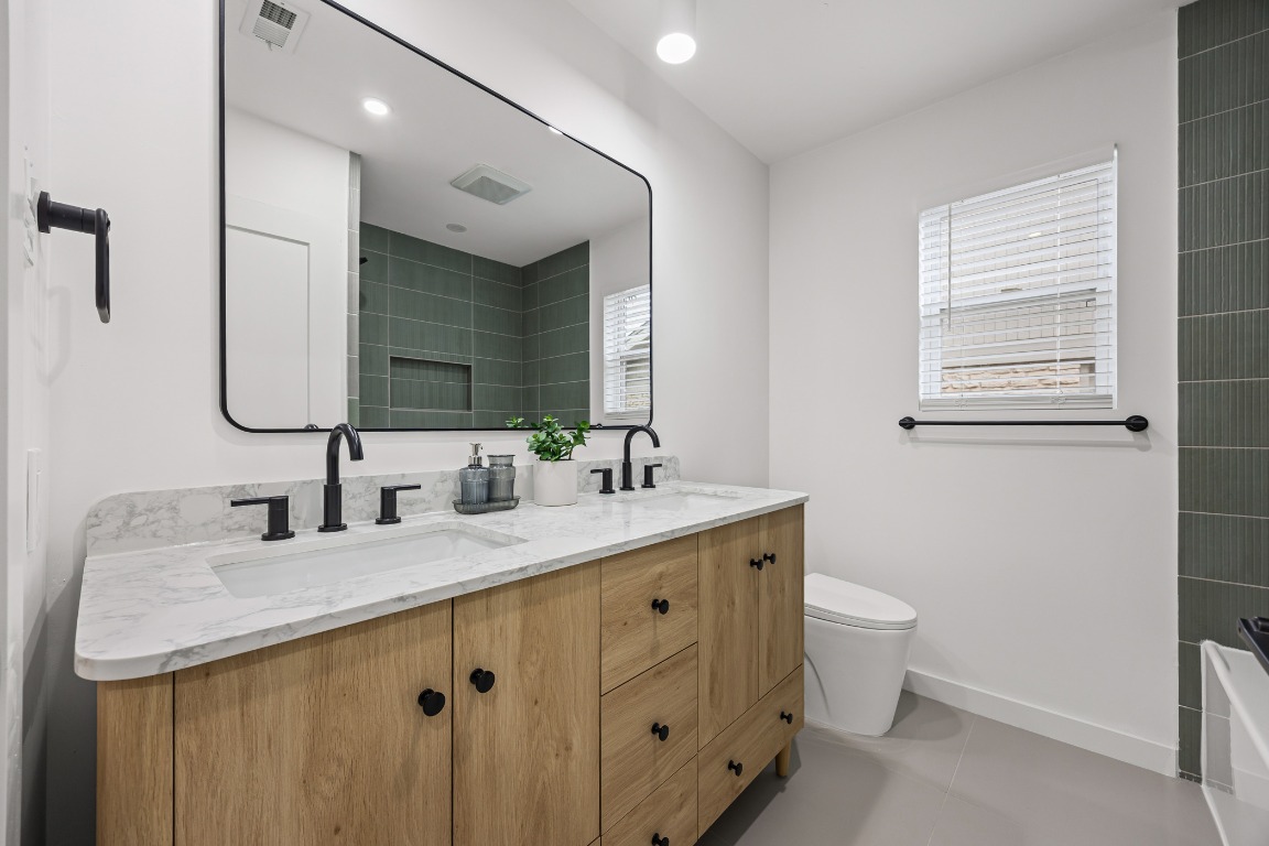 4609 Cliffstone Cove Austin, TX 78735 - Photo 19 of 33 Full bath featuring double vanity and baseboards