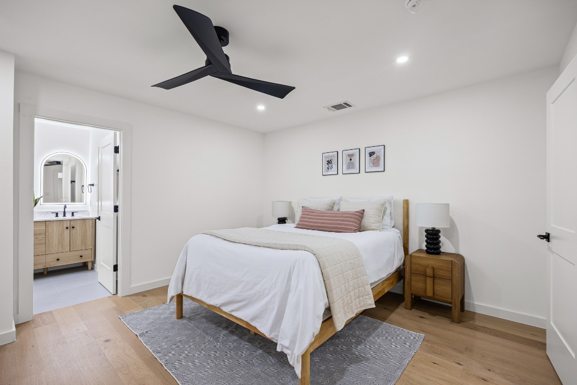 4609 Cliffstone Cove Austin, TX 78735 - Photo 23 of 33 Bedroom with light wood-style flooring, a ceiling fan, recessed lighting, and ensuite bath