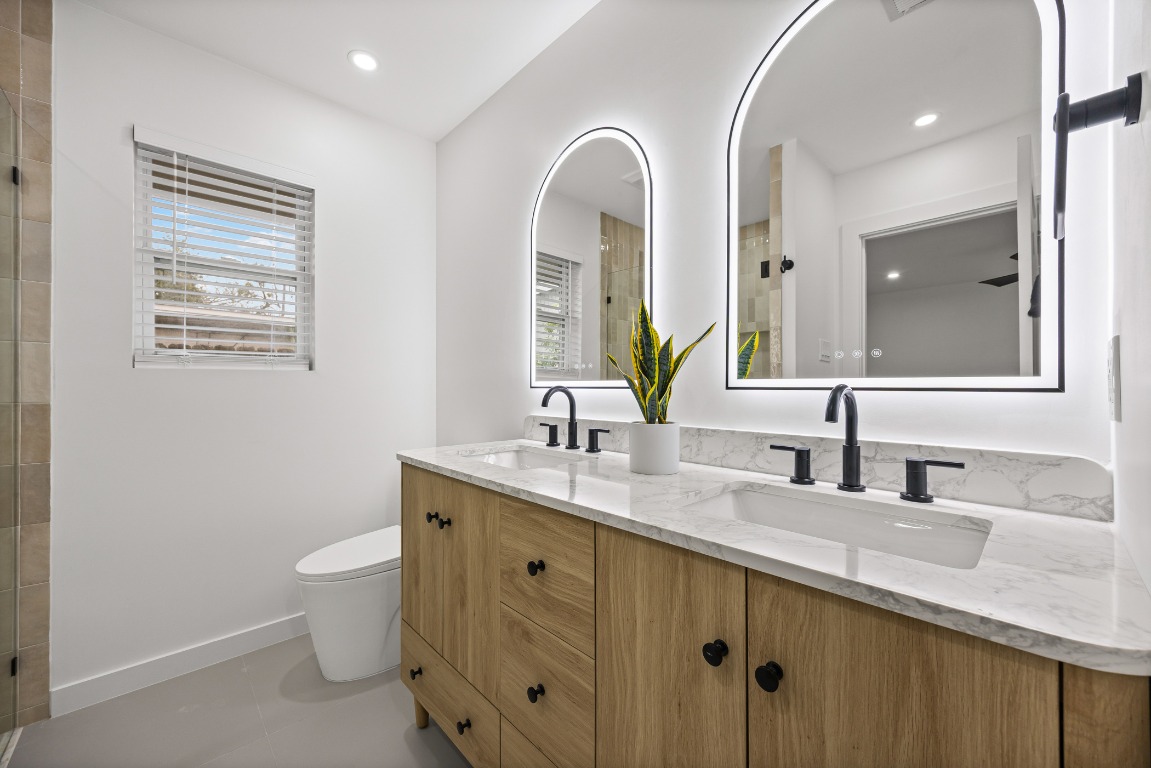 4609 Cliffstone Cove Austin, TX 78735 - Photo 24 of 33 Full bathroom with double vanity, tiled shower, and recessed lighting