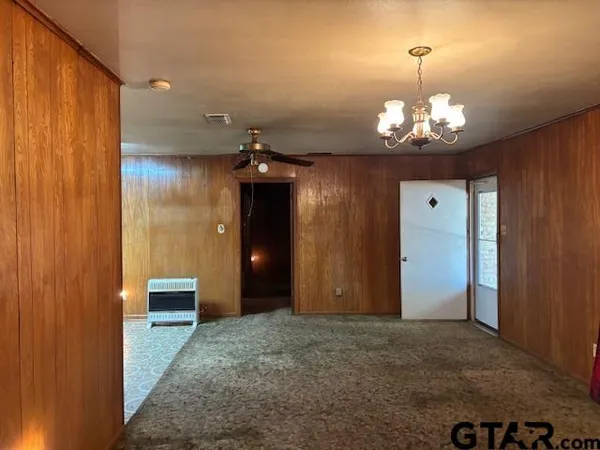 a view of a room with furniture and a ceiling fan