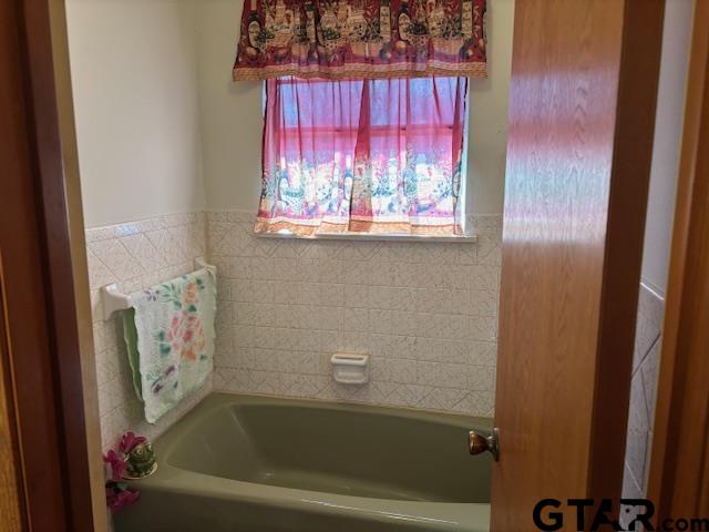 152 County Road 2131 Rusk, TX 75785 - Photo 25 of 43 a bathroom with a bathtub and window