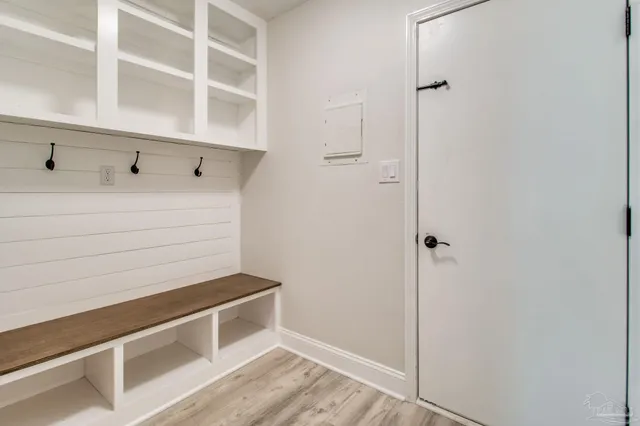 an empty room with wooden floor a fireplace and windows