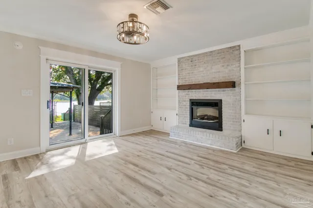 a view of a kitchen with furniture and wooden floor