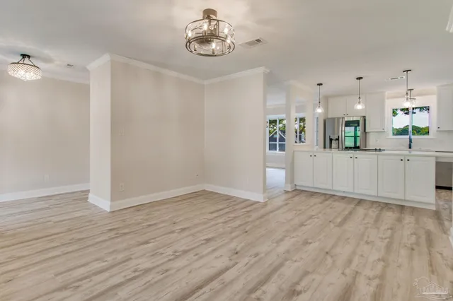 a view of a room with wooden floor and white walls