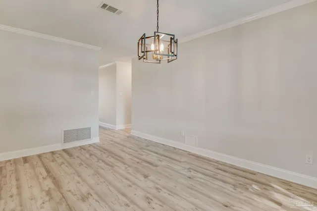 a view of a kitchen with wooden floor and a sink