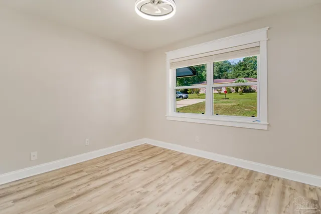 an empty room with wooden floor