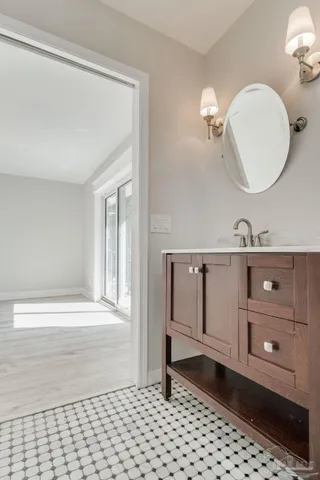 a bathroom with a sink a toilet and a mirror
