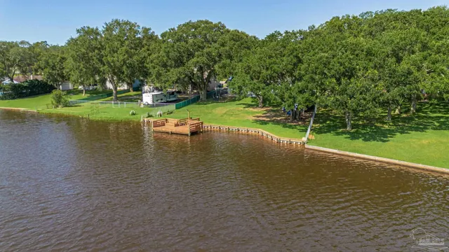 a view of a swimming pool with a patio and a yard