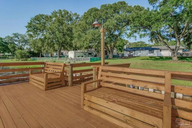 a view of a swimming pool with a bench in a park