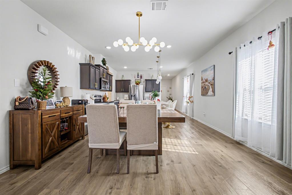 1301 Draper Lane Forney, TX 75126 - Photo 11 of 33 a view of a dining room with furniture and wooden floor