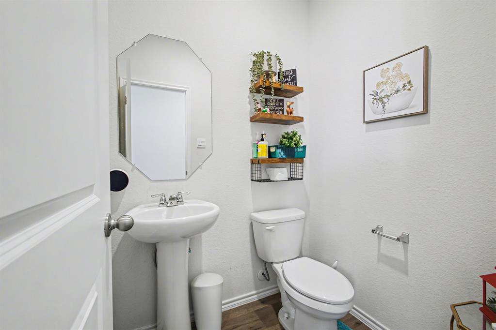 1301 Draper Lane Forney, TX 75126 - Photo 18 of 33 a bathroom with a toilet sink and mirror