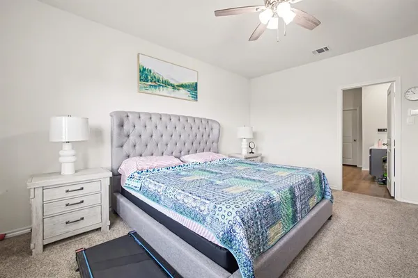 a bedroom with a bed and a dresser