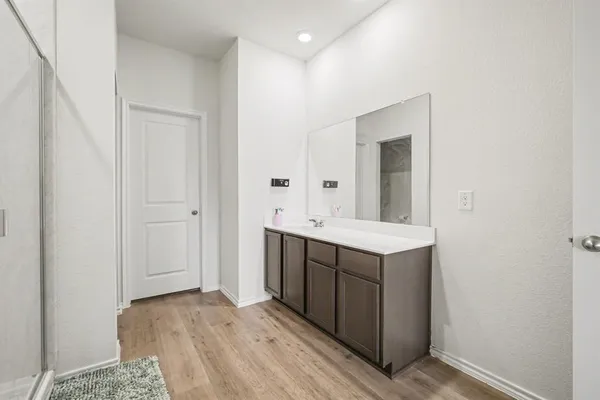 a bathroom with a sink vanity and mirror
