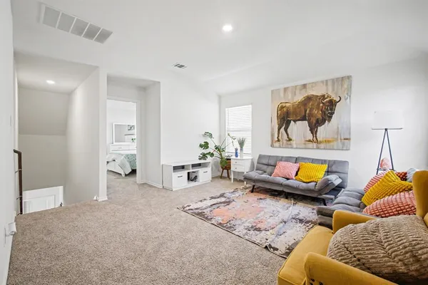 a living room with furniture and painting on the wall