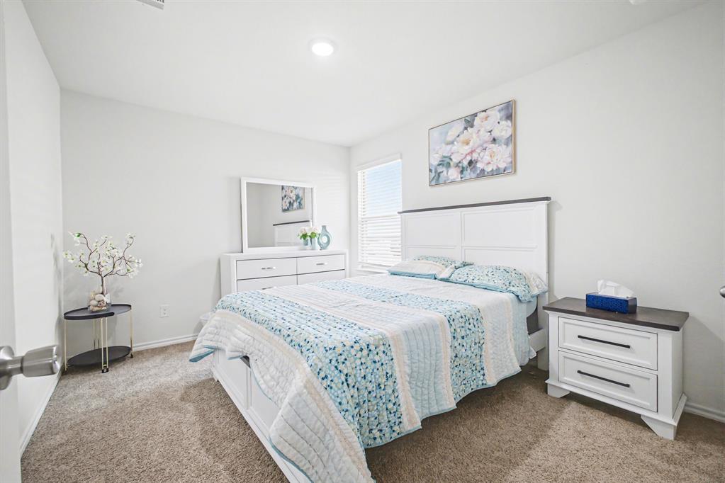 1301 Draper Lane Forney, TX 75126 - Photo 29 of 33 a bedroom with a bed and lamp