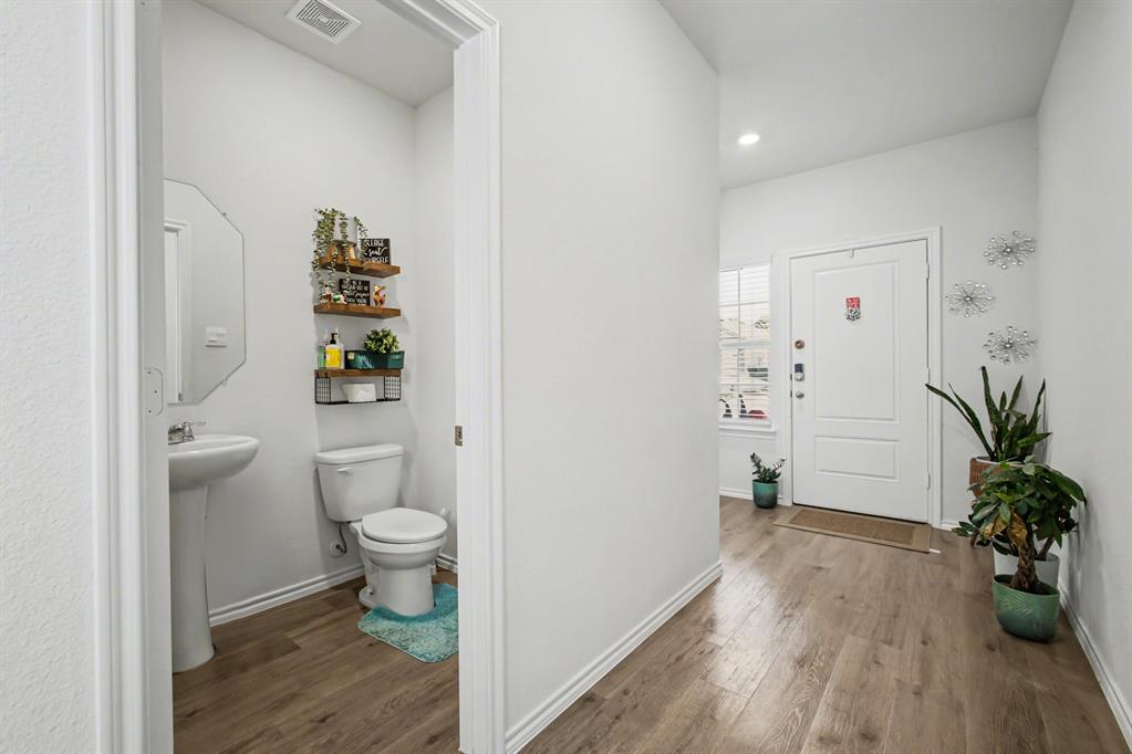 1301 Draper Lane Forney, TX 75126 - Photo 6 of 33 a bathroom with a toilet and a potted plant