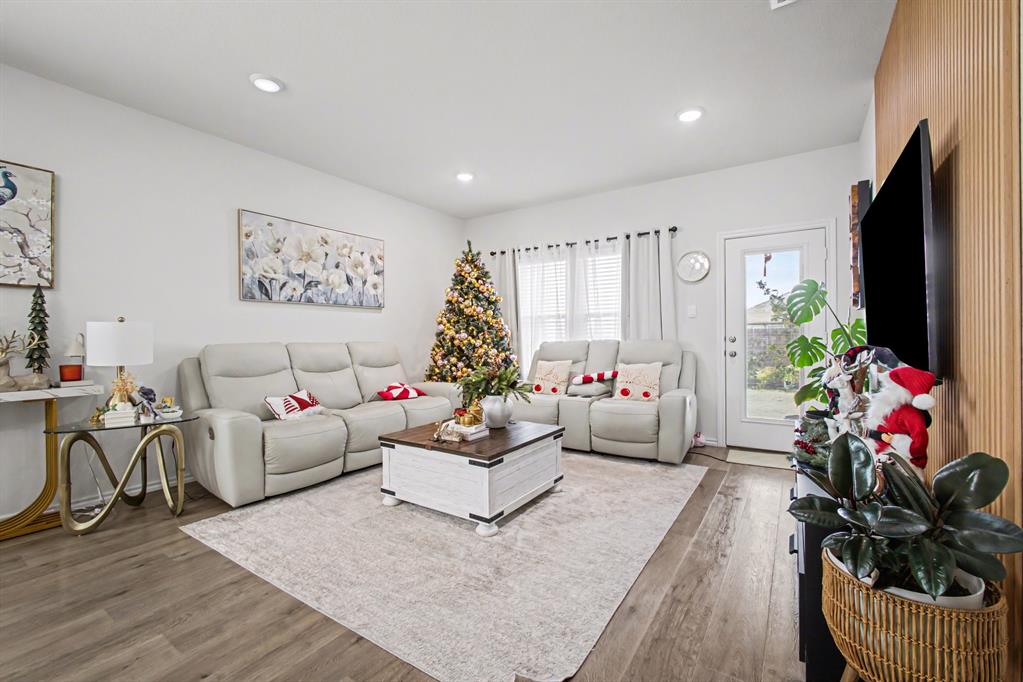 1301 Draper Lane Forney, TX 75126 - Photo 7 of 33 a living room with furniture potted plant and a flat screen tv