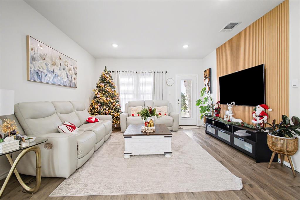 1301 Draper Lane Forney, TX 75126 - Photo 8 of 33 a living room with furniture and a flat screen tv