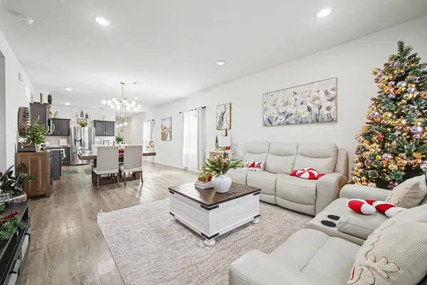 a living room with furniture and flowers
