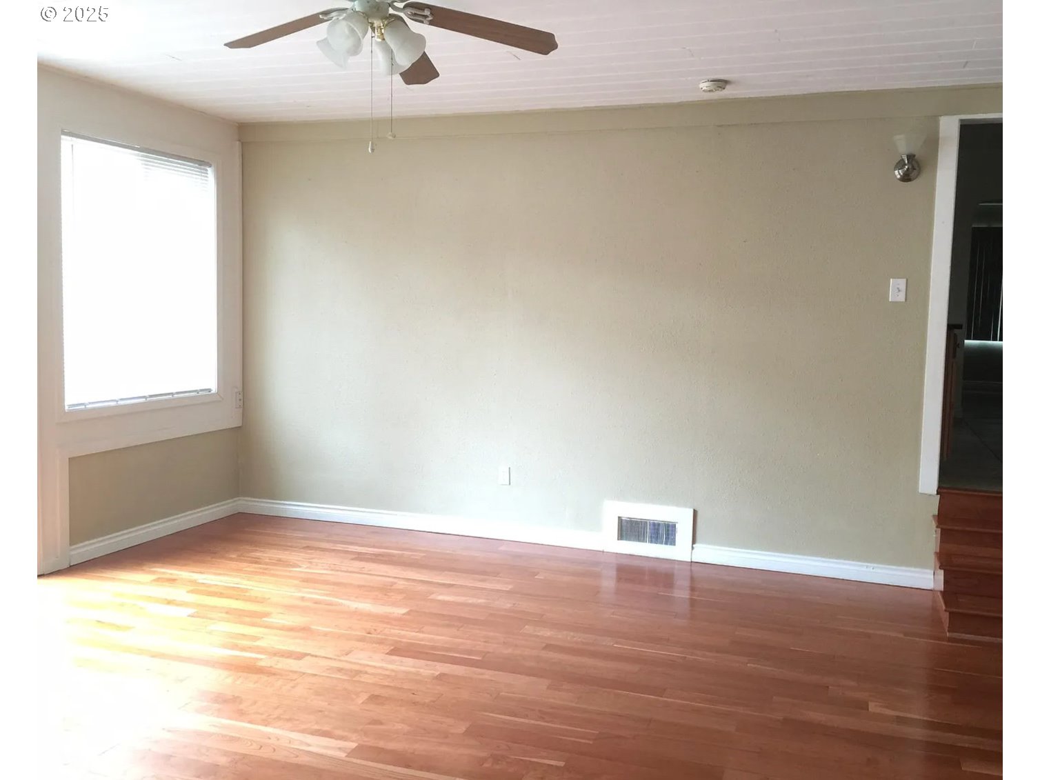 12025 Southwest 9th Street Beaverton, OR 97005 - Photo 11 of 22 a view of an empty room with window and wooden floor