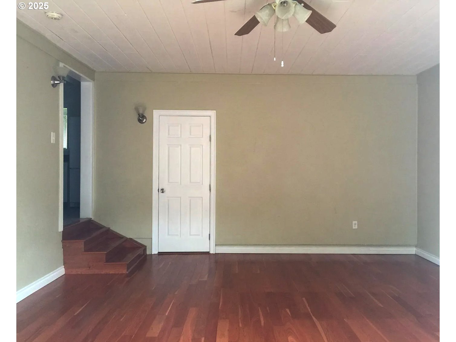12025 Southwest 9th Street Beaverton, OR 97005 - Photo 12 of 22 an empty room with wooden floor and chandelier fan