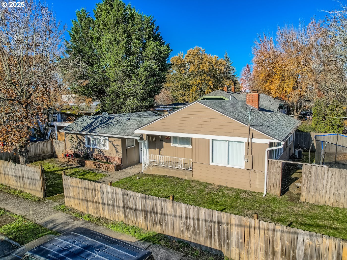 12025 Southwest 9th Street Beaverton, OR 97005 - Photo 14 of 22 a view of a white house with large windows and a small yard